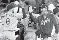  ?? AP/LENNY IGNELZI ?? Kansas City Royals Manager Ned Yost (right) celebrates with Mike Moustakas after the Royals’ 3-2 victory over the Los Angeles Angels in 11 innings Thursday in Anaheim, Calif. Moustakas hit a home run in the 11th inning and the Royals took a 2-0 lead in...