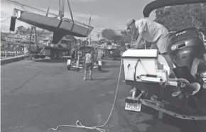  ?? STEVE HEASLIP/CAPE COD TIMES VIA AP ?? Baxter Crane Co. hauls a sailboat onto a trailer Friday in Hyannis, Mass. The company was busy all day with boaters hauling out ahead of Hurricane Henri.