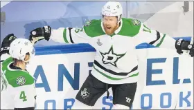  ?? JASON FRANSON— THE ASSOCIATED PRESS ?? Dallas Stars’ Joe Pavelski, left, celebrates his goal against the Tampa Bay Lightning with teammate Miro Heiskanen in the Stars’ overtime win in Game 5of the Stanley Cup Finals.