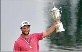  ?? JAE C. HONG / AP ?? Rahm holds up the champions trophy after the final round of the U.S. Open.