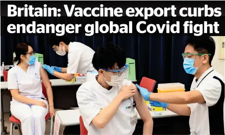  ?? AP ?? Medical workers receive doses of Pfizer’s vaccine at the Tokyo Metropolit­an Cancer and Infectious Diseases Centre in Komagome Hospital. —