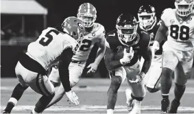  ?? MATT BUSH/USA TODAY SPORTS ?? Mississipp­i State running back Jo’quavious Marks runs the ball against Georgia defensive back Kelee Ringo, left, during the fourth quarter on Nov. 12 at Davis Wade Stadium at Scott Field.