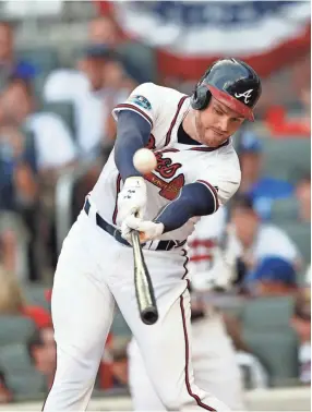  ??  ?? Braves first baseman Freddie Freeman bats against the Dodgers during Game 4 of the NL Division Series on Monday.