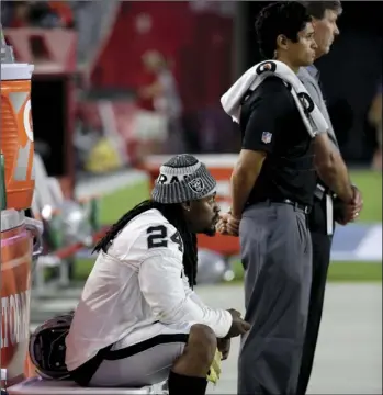  ??  ?? Oakland Raiders running back Marshawn Lynch sits during the national anthem prior to the team's NFL preseason football game against the Arizona Cardinals on Saturday in Glendale, Ariz. AP PHOTO/RICK SCUTERI