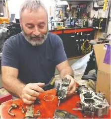  ??  ?? Patrick Mccready cleans and rebuilds the carburetor for his truck project.