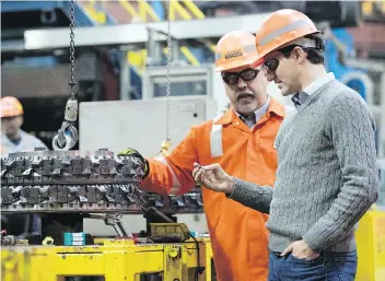  ?? TROY FLEECE ?? Prime Minister Justin Trudeau listens to Scott Manson, director of operations for Regina Tubular Group, during a tour of Evraz Tubular Operations in Regina on Wednesday.