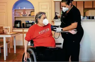  ?? ?? Nurse Yolanda Torres checks the vitals for Chris Salas, who suffered a spinal cord injury.