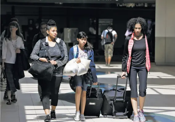  ?? Photos by Paul Chinn / The Chronicle ?? Sandra Salazar (right) walks with daughters Maya (left) and Nubia, who will accompany her to Phoenix then Mexico, at Sacramento Internatio­nal Airport.