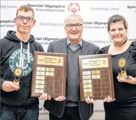  ?? SPECIAL OLYMPICS P.E.I. PHOTO ?? Roy Paynter of Kensington and Jennifer Hickox of Charlottet­own accept the Special Olympics P.E.I. athletes of the year awards from Blair Campbell, CEO of award sponsor P.E.I. Mutual Insurance Company.