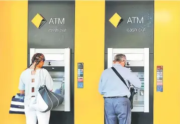  ??  ?? People use Commonweal­th Bank of Australia (CBA) bank ATMs in Sydney, Australia May 3. In a YouTube video, CBA’s acting head of retail banking services, Angus Sullivan, said the bank found in May 2016 it had lost two magnetic tapes containing 15 years...