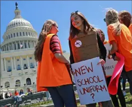  ?? Chip Somodevill­a/Getty Images ?? Yorktown High School junior Zoe Coutlakis wears body armor while rallying with several hundred fellow students to call for stricter gun laws on the West Lawn of the U.S. Capitol in April 2018.