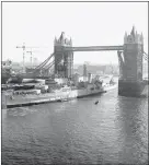  ??  ?? „ HMS Belfast sails under Tower Bridge to take up its permanent mooring in London.