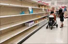  ?? Jim Watson / AFP via Getty Images ?? A woman shops for baby formula on Monday at a Target store in Annapolis, Md., as a nationwide shortage continues.