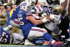  ?? Associated Press ?? New Orleans Saints running back Mark Ingram (22) rushes past Buffalo Bills' Kyle Williams (95) to score a touchdown during the first half of an NFL football game Sunday in Orchard Park, N.Y.