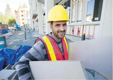  ?? MARK VAN MANEN ?? Hasan Al Sheblak is a government-assisted refugee from Syria who started his own tiling business, which employs up to six fellow Syrians at a time. A participan­t in a recent refugee survey, he says he is “very, very happy” to be in Canada with his wife...