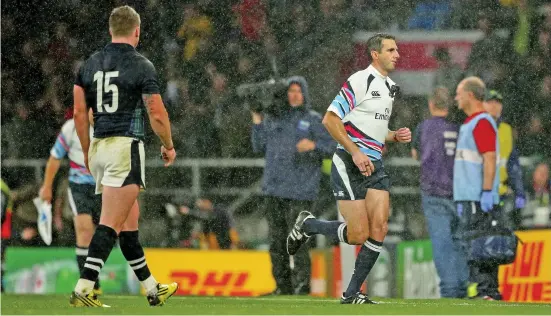  ??  ?? He’s off: referee Joubert makes his way towards the tunnel immediatel­y after blowing his whistle as Stuart Hogg looks on