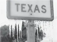  ?? JOE RAEDLE/ GETTY IMAGES ?? Icicles hang from a highway sign on Feb. 18 in Killeen, Texas. A winter storm brought historic cold weather and power outages to Texas.