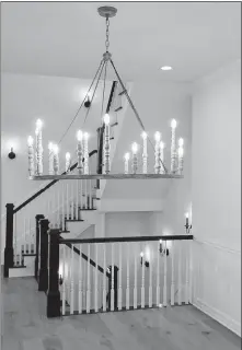  ?? [ERIC ALBRECHT/DISPATCH PHOTOS] ?? A grand staircase is accented by a “candle” chandelier in the “girl” home.