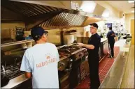  ?? Tyler Sizemore / Hearst Connecticu­t Media ?? Owner Jonathan Langsam, center, in July in the kitchen of the new Falafel Taco in Greenwich. The leisure and hospitalit­y sector added 2,000 jobs in September, No. 1 among sectors, according to state Department of Labor data.