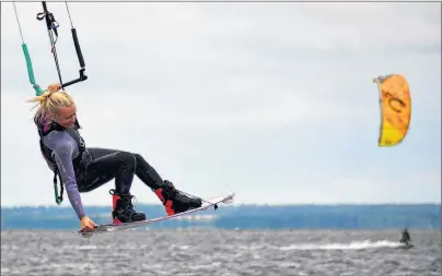  ?? DESIREE ANSTEY/ JOURNAL PIONEER ?? Lauren Holman, from Vancouver, touches the sky with her kiteboard in Malpeque Bay. “It’s not just a good pastime, but good to do with friends, brings people closer and creates a community,” she said.