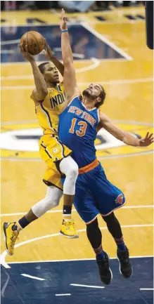  ??  ?? INDIANAPOL­IS: Indiana Pacers guard Glenn Robinson III, left, goes up to shoot as he is defended by New York Knicks center Joakim Noah (13) during the second half of an NBA basketball game, Saturday, in Indianapol­is.—AP