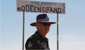  ?? AFP PIC ?? Senior Constable Stephan Pursell watching traffic approachin­g from South Australia at the remote Queensland border outside Birdsville.