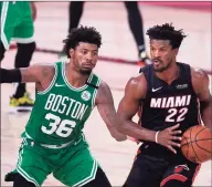  ?? Mark J. Terrill / Associated Press ?? The Celtics’ Marcus Smart (36) defends as the Heat’s Jimmy Butler looks to make a pass during Saturday’s playoff game in Lake Buena Vista, Fla.