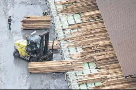  ?? THE CANADIAN PRESS ?? Workers sort and move lumber at the Delta Cedar Sawmill in Delta, B.C.. As softwood negotiatio­ns with the United States languish, the Canadian government says it’s readying itself for the next phase of the lumber fight: litigation.