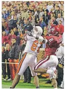  ?? [PHOTO BY NATE BILLINGS, THE OKLAHOMAN ARCHIVES] ?? OSU receiver Rashaun Woods goes for a touchdown catch in front of OU’s Derrick Strait in the fourth quarter during Bedlam in 2001. Woods made the catch to win the game.