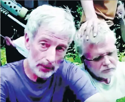  ?? YOUTUBE ?? Two Canadians kidnapped in the southern Philippine­s three weeks ago have surfaced in a video with what appear to be Abu Sayyaf gunmen who demand a halt to military operations against them before negotiatio­ns can begin. In the video the hostages...