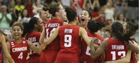 ?? RICHARD LAUTENS/TORONTO STAR ?? The Canadian women’s basketball team celebrates a groundbrea­king win over the United States in the Pan Am gold-medal game.