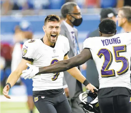  ?? DUANE BURLESON/AP ?? Ravens kicker Justin Tucker, left, celebrates with Tavon Young after kicking an NFL-record 66-yard field goal to beat the Lions on Sunday.