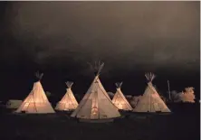  ?? TNS ?? Fires burn in all five of the teepees in the predawn hour at El Cosmico in Marfa, Texas.