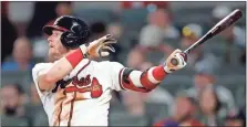  ?? John Bazemore ?? Braves’ Josh Donaldson follows through on a solo home run in the sixth inning against the Dodgers in Atlanta on Saturday.