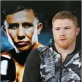  ?? KATHY WILLENS — THE ASSOCIATED PRESS ?? Six-time boxing title holder Saul “Canelo” Alvarez, right, of Mexico sits beside a giant photograph of upcoming opponent, IBF and WBC world middleweig­ht champion Gennady Golovkin during an interview, Tuesday in New York.