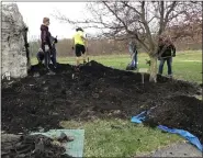  ?? ?? Members of Shoemakers­ville Scout Troop 163 get the flowerbeds ready for planting at Perry Township Recreation Area.