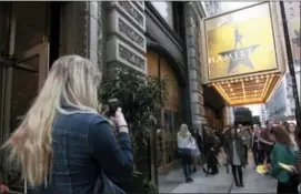  ?? CARRIE ANTLFINGER — THE ASSOCIATED PRESS ?? In this photo taken Alex Richards takes a photo of Meera Ganesh outside the CIBC Theatre after watching “Hamilton: An American Musical” in Chicago.