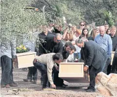  ??  ?? FINAL GOODBYE: Family and friends gather for a service for Dawna Ray Langford, 43, and her sons Trevor, 11, and Rogan, 2, in La Mora, Mexico on Thursday.