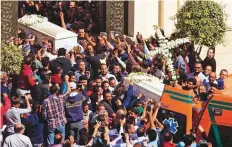  ?? AP ?? Relatives and friends carry the coffins of two of the victims after the funeral service in Minya yesterday.