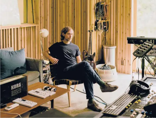  ?? DANIEL DORSA/THE NEW YORK TIMES ?? Aaron Dessner sits July 17 in his studio near his home in New York. Dessner’s recording project Big Red Machine recently released its second album.