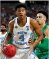  ?? Associated Press ?? n North Carolina’s Isaiah Hicks drives against Oregon’s Keith Smith on Saturday during the first half in Glendale, Ariz.