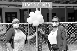  ??  ?? Acting principal of Titchfield High School Sheryl Horne-Mair (right) and board member Elaine Williams beside the newly erected sign for Lloyd O. Chin Drive on the institutio­n’s campus, following the ribbon-cutting ceremony on November 11.