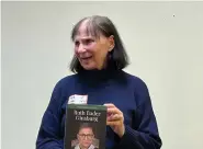  ?? (Submitted photo) ?? Nancy Hendricks shows a copy of her new book, “Ruth Bader Ginsburg: A Life in American History (Women Making History)” during the Virginia Clinton Kelley Democratic Women annual holiday party.