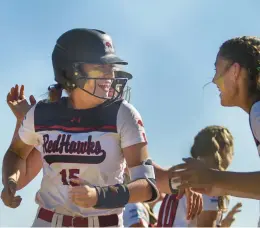  ?? VINCENT D. JOHNSON/DAILY SOUTHTOWN ?? Marist’s Isabel Cunnea, left, is greeted by teammates after hitting a home run during the Class 4A Marist Supersecti­onal on Tuesday.