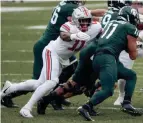  ?? JOSHUA A. BICKEL/COLUMBUS DISPATCH ?? Ohio State defensive end Tyreke Smith tackles Michigan State running back Connor Heyward on Dec. 5.