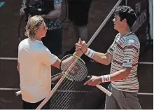  ?? FRANCISCO SECO THE ASSOCIATED PRESS ?? Denis Shapovalov, left, from Canada shakes hands with countryman Milos Raonic a during a Madrid Open tennis tournament match Thursday. Shapovalov won the match, 6-4, 6-4.