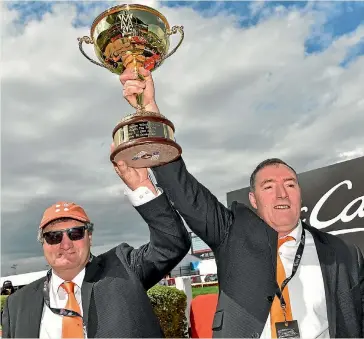  ?? GETTY IMAGES ?? Shaun O’Leary, left, and brother Humphrey hold aloft the the Moonee Valley Cup after Who Shot Thebarman’s win.