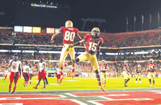  ?? GETTY IMAGES ?? Florida State’s Rashad Greene and Greg Dent celebrate after Greene scored on a six-yard reception against Northern Illinois in the Orange Bowl on Jan. 1, 2013.