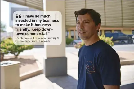  ??  ?? Jacob Zavala, owner of El Dorado Printing & Embroidery Services in El Centro, talks about the reasons why a transition­al home that wants to open across the street from his shop (below) would hurt downtown businesses. MARIO RENTERIA PHOTOS