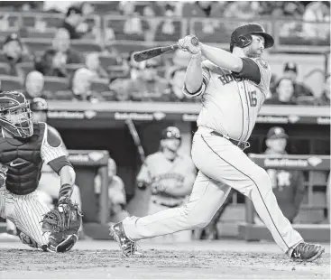  ?? Frank Franklin II photos / Associated Press ?? The Astros’ Brian McCann flashes his classic Babe Ruth swing at Yankee Stadium on Friday night. It produced a decisive three-run clout that broke open a scoreless game.